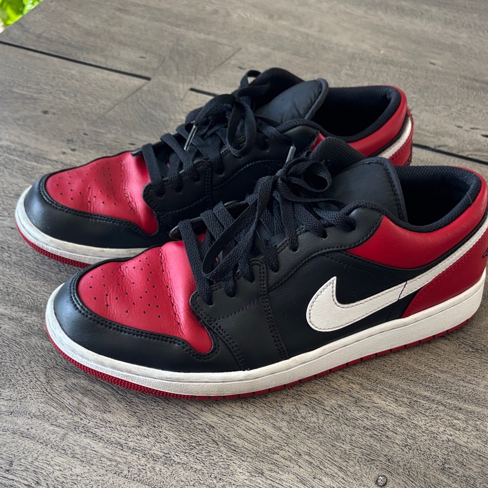 Jordan AJ 1 Low Black and Red Sneakers with White Swoosh